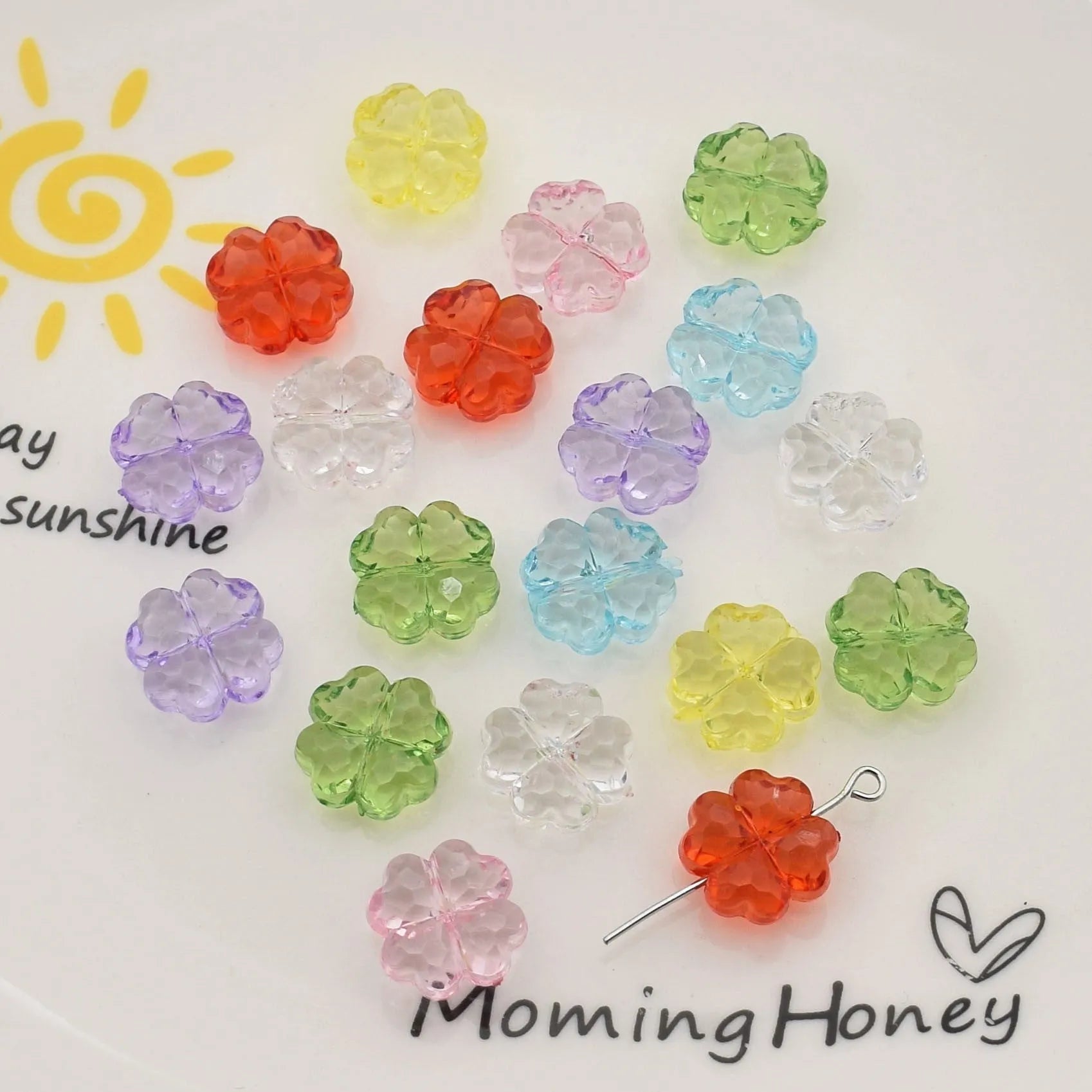 High transparency acrylic fat clover camellia beads scattered on white surface