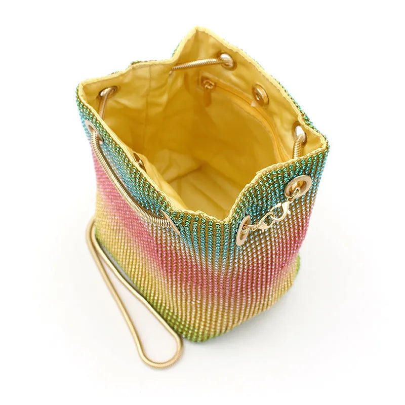Colourful rhinestone bucket bag with glittery crystal embellishment and soft fabric construction