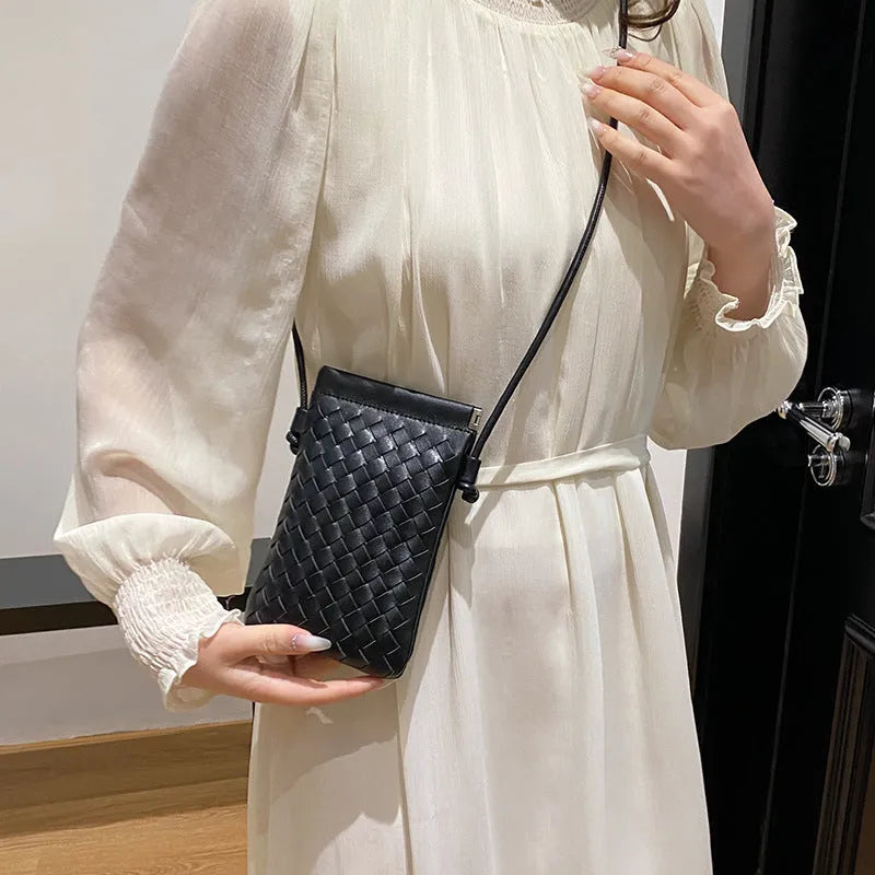 Vintage weave crossbody bag in retro style showing square vertical shape and woven texture