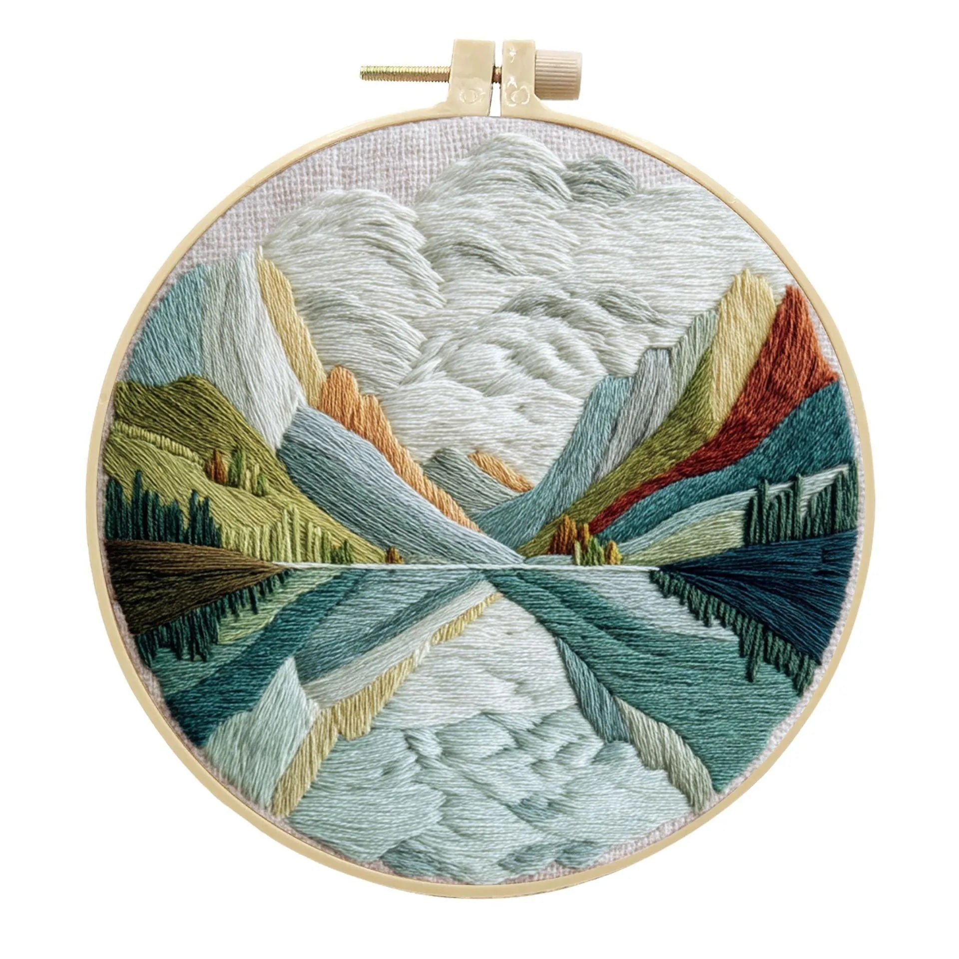 Embroidery DIY kit with bamboo frame, cotton fabric printed with a landscape scene, threads, and needles laid out