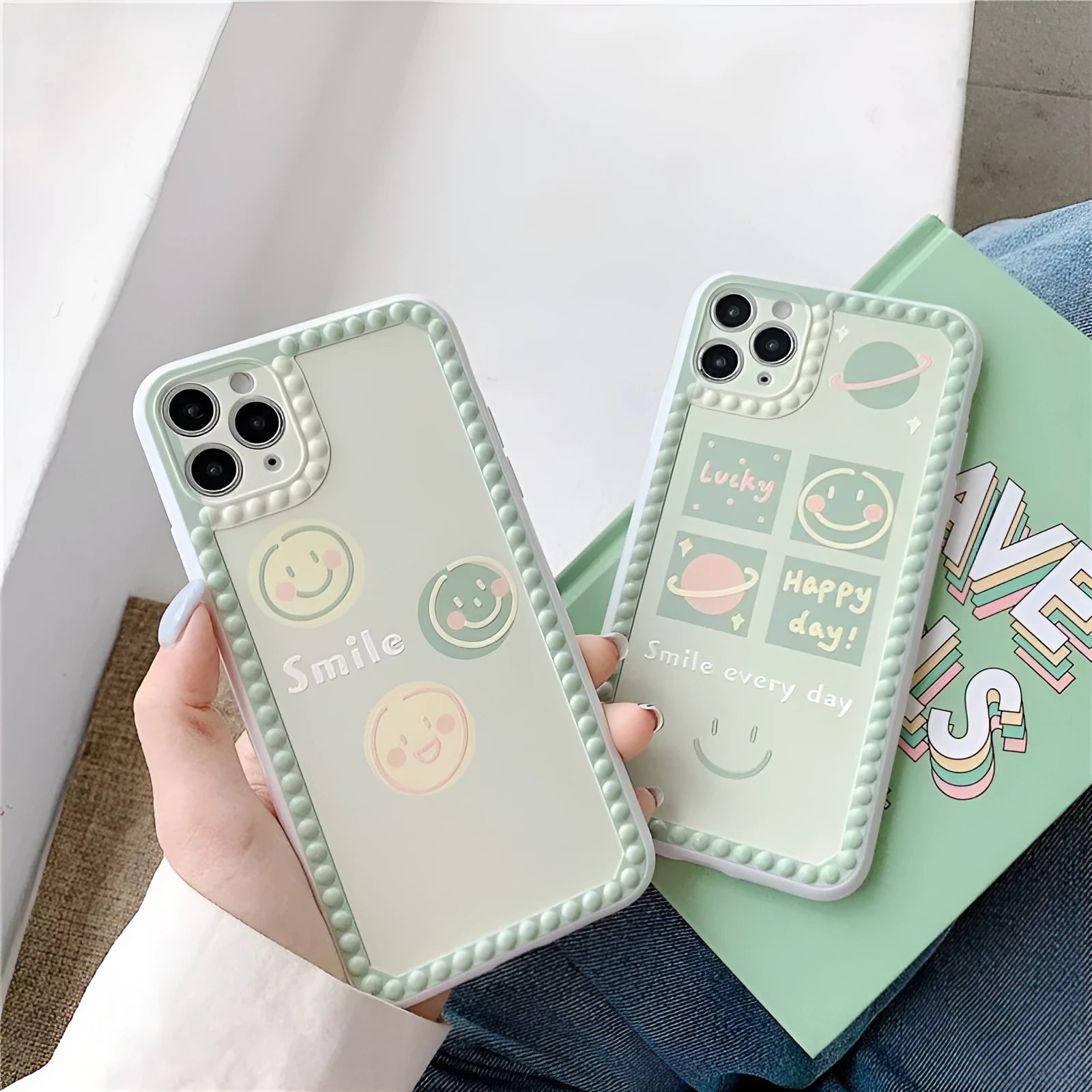 Green iPhone case with smiley face and white polka dot geometric design on the back.