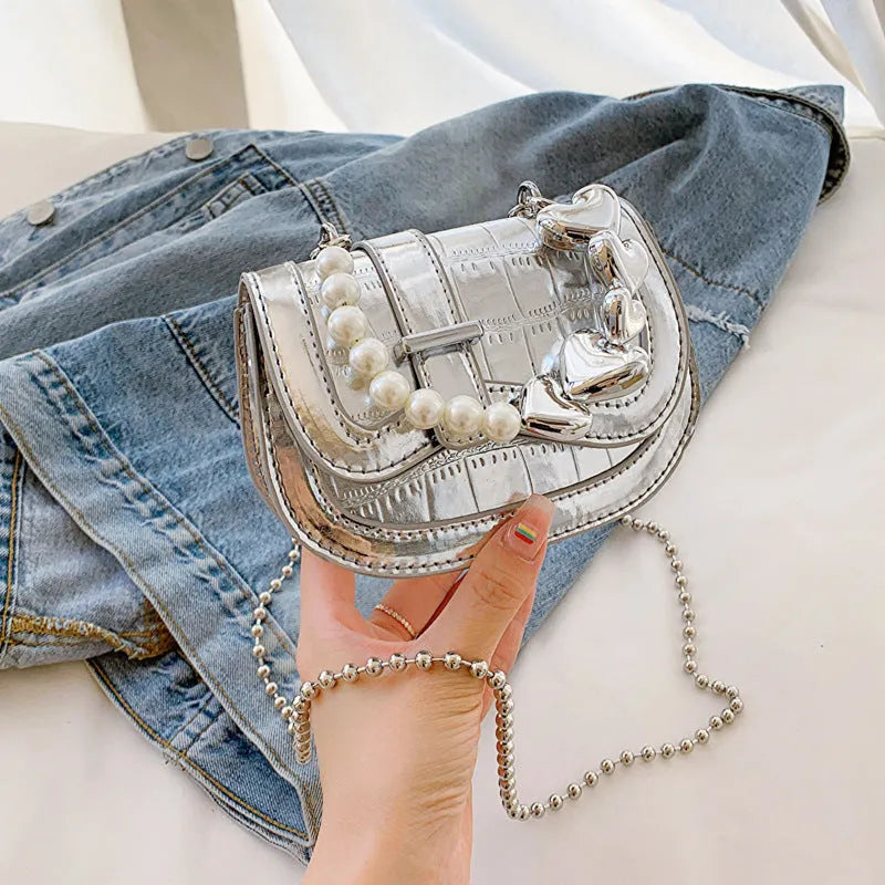 Silver laser pearl women's mini crossbody bag with a horizontal square shape and single shoulder strap.