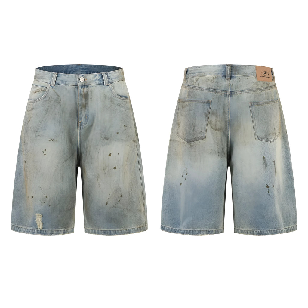 A pair of washed blue, cropped, straight-leg denim trousers on a plain background.