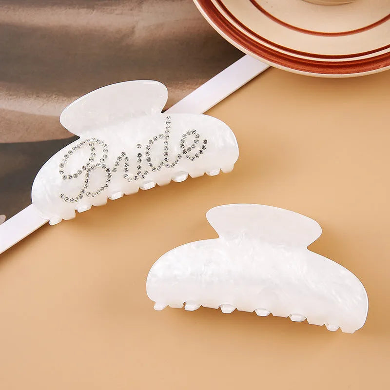 Acrylic hair clip with spot drill decoration in pink or white, 10cm long.