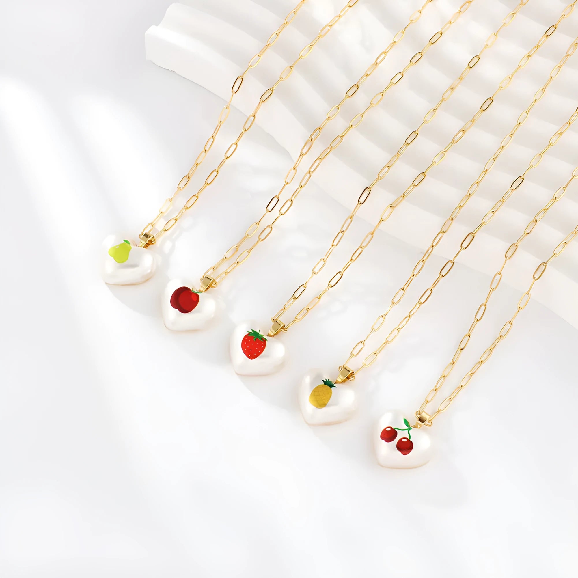 Fruit charm necklace with adjustable chain showing strawberry, pineapple, apple, pear and cherry pendant options