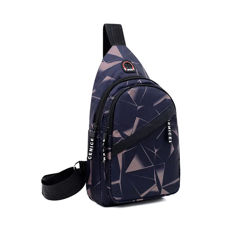 Men's blue Oxford cloth crossbody sling bag showing earphone hole and front zipper.
