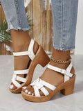 Plus size women's black peep toe sandals with a chunky heel and buckle ankle strap
