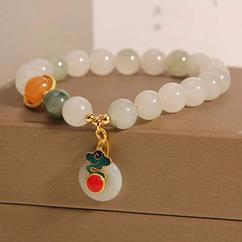 Women's jade crystal bracelet with ice jade colour, pearl accents, and peace jade buckle