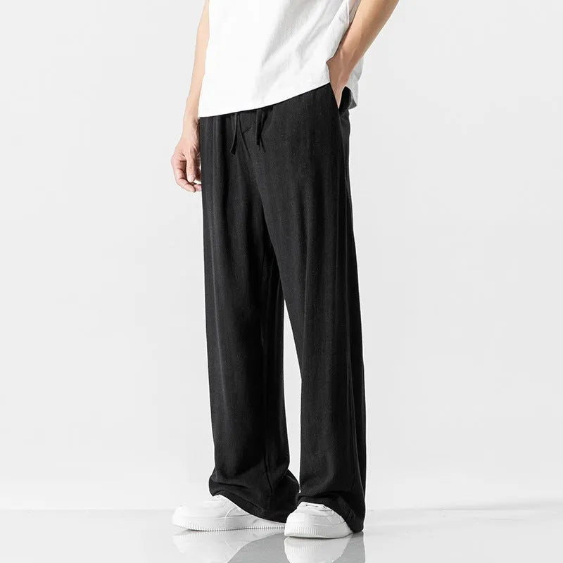 Men's cropped linen trousers in bamboo fibre with a loose straight-leg fit and drawstring waist.