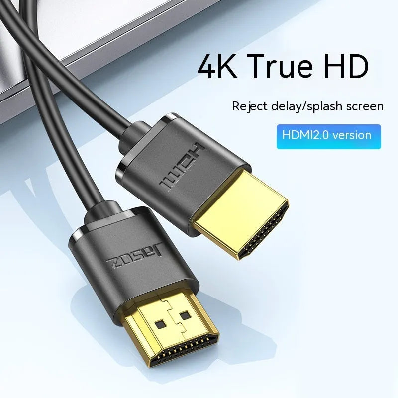 Flexible thin HDMI cable with gold-plated connectors and HDMI hairline rule design on a white background.