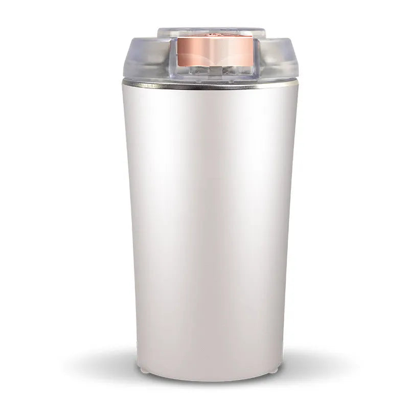 Blue electric mini flour mill and grain grinder with stainless steel construction on a kitchen countertop.