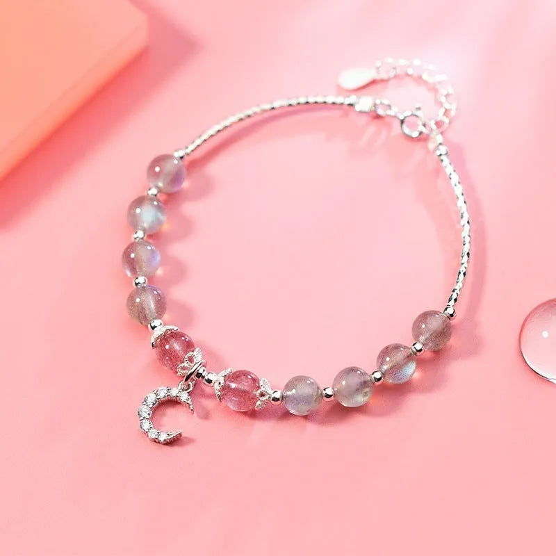 Natural moonstone bracelet with extension chain showing crescent moon and crystal accents