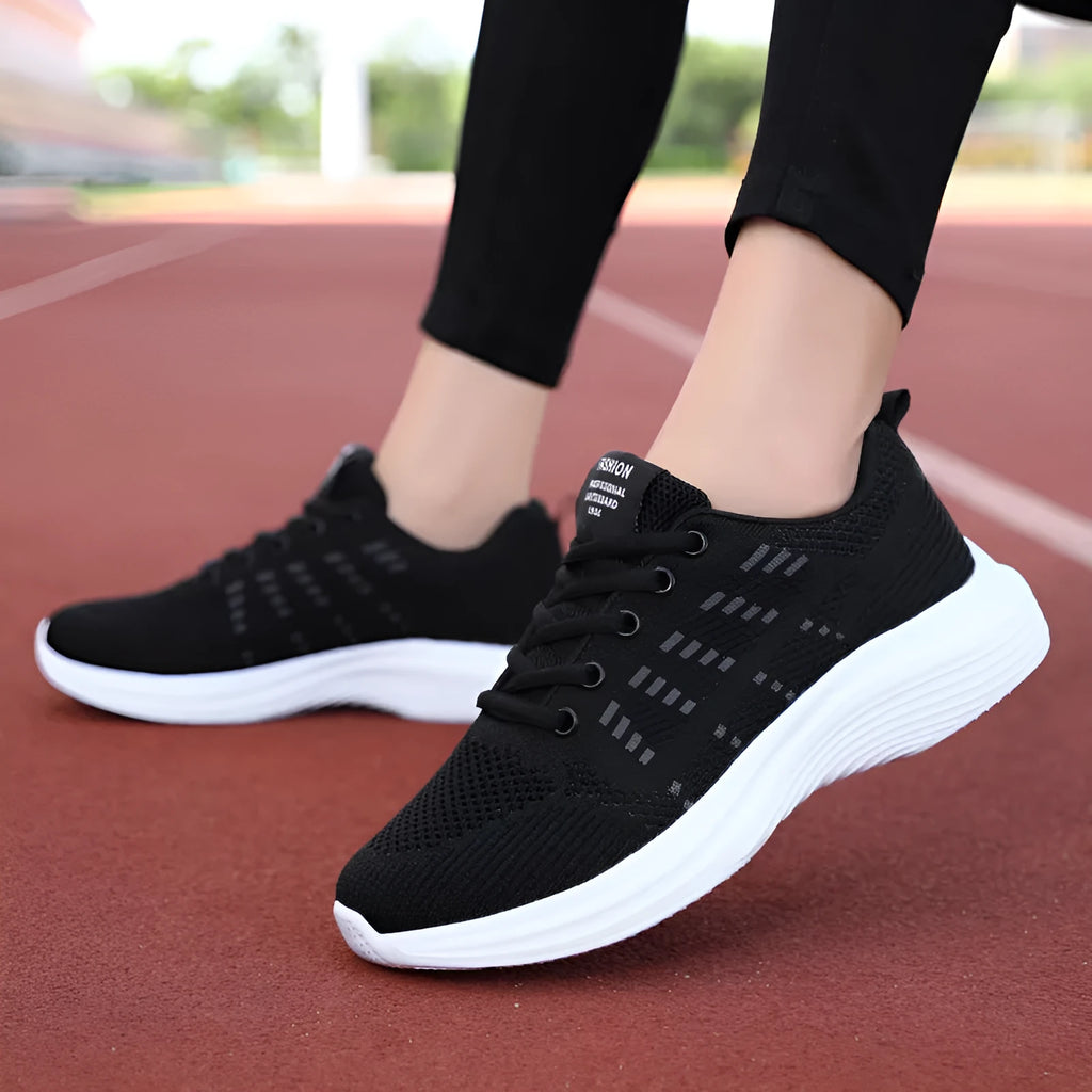 Women's black mesh breathable non-slip sneaker with lace-up front and flat heel, side view