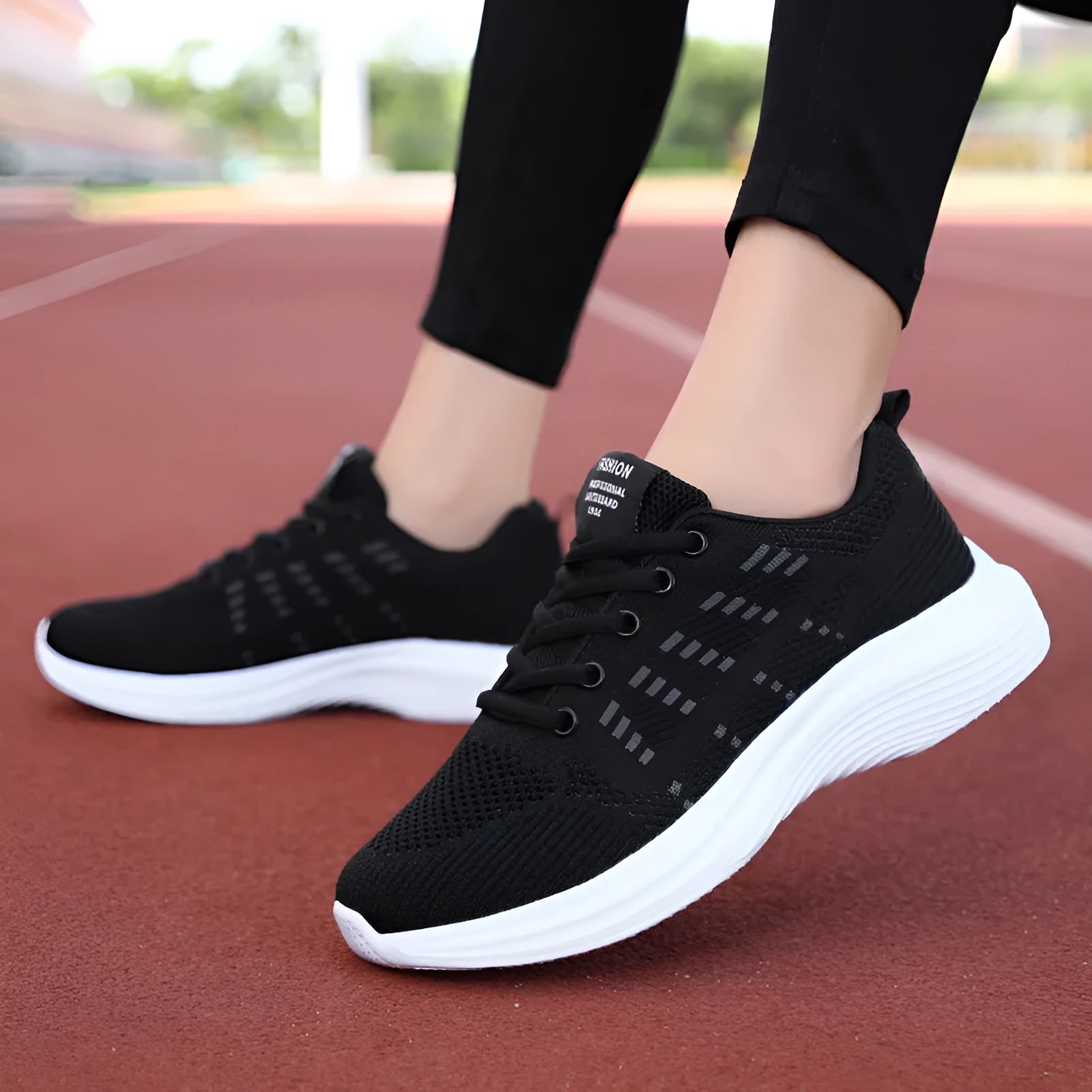Women's black mesh breathable non-slip sneaker with lace-up front and flat heel, side view