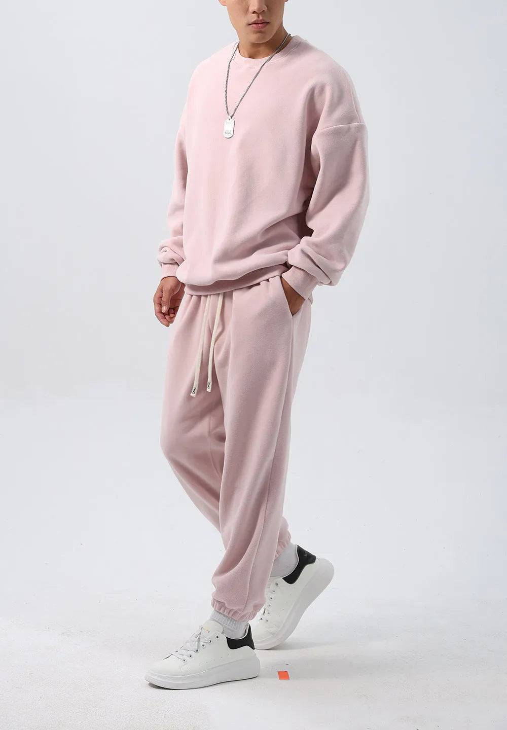 Men's polar fleece tracksuit set showing crew neck top with padded trousers in winter sportswear style