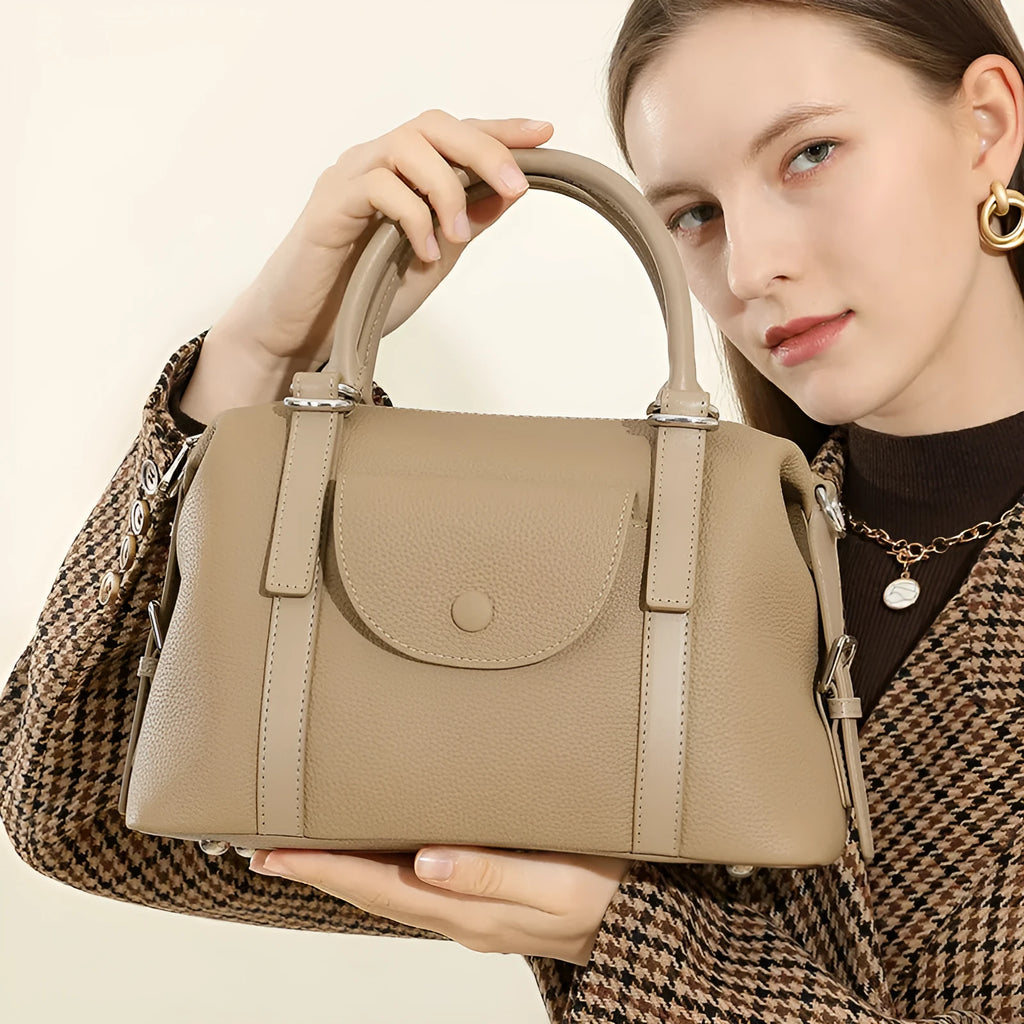 Genuine leather street trend handbag with lock detail and contrast stitching in 27x12x20 cm size