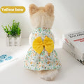 Orange floral butterfly pet dress with a bow on a dog, showing thin summer clothing.