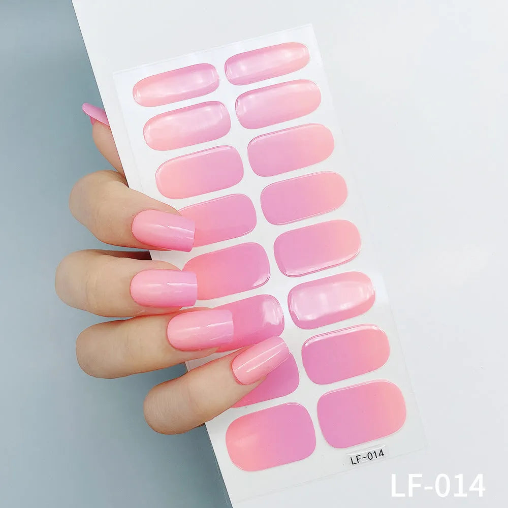 Full sheet of nail art stickers showing sixteen small designs including cross, rose, tulip, and leopard print patterns.