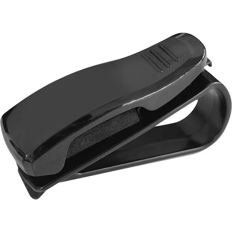 Black plastic clip for holding glasses and cards on a car sunshade