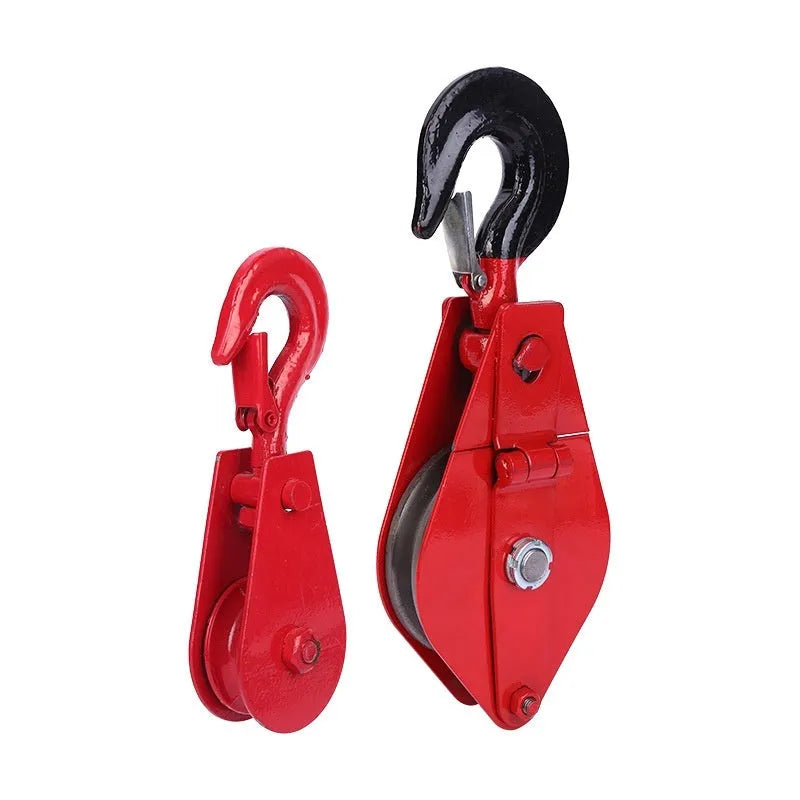 Red industrial steel lifting pulley with a safety latch on the hook.
