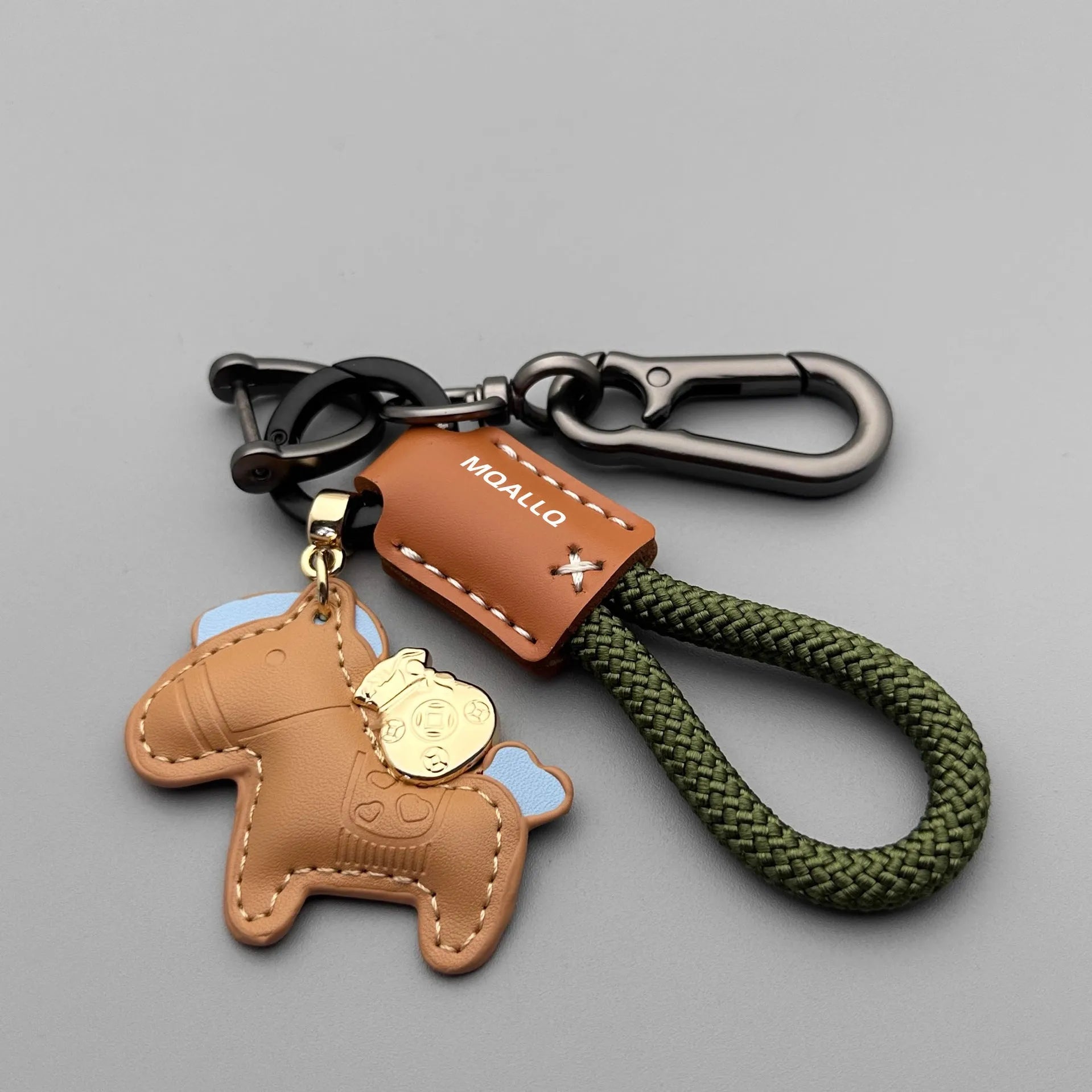 Zinc alloy car keychain pendant with a strap made of brown cowhide and green flannel rope.