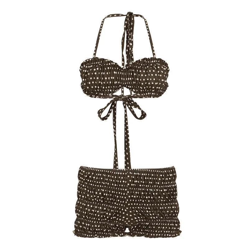 Brown polka dot women's shorts suit with sleeveless strap top and matching shorts on a summer seaside backdrop