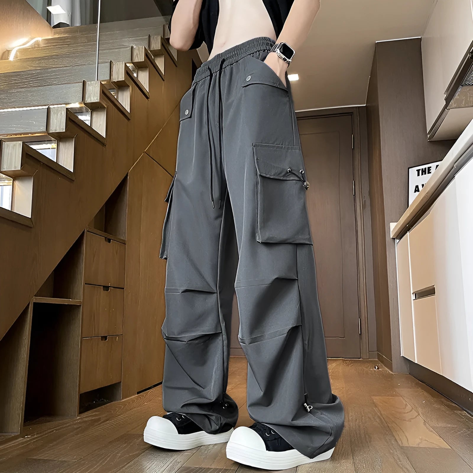 Plus size black waterproof loose straight-leg trousers with drawstring waist on hanger
