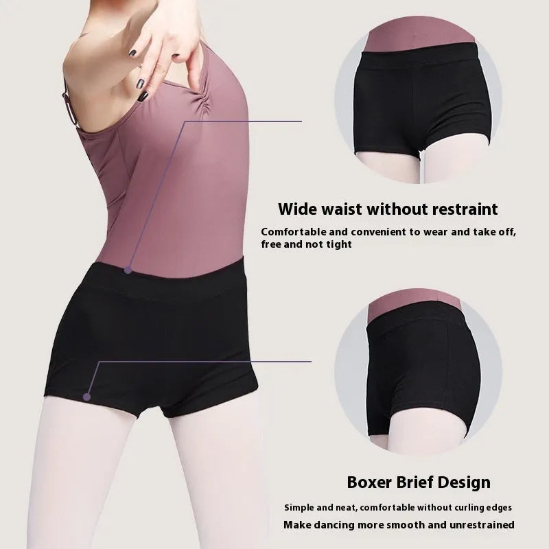Black cotton dance shorts for women laid flat, showing solid colour and simple design for ballet practice.