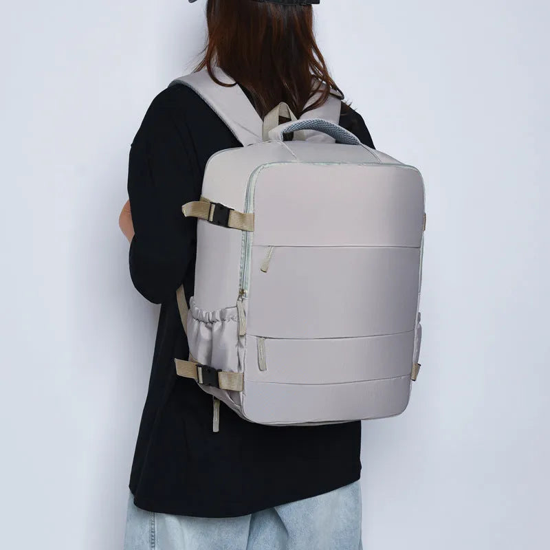 Women's lightweight waterproof solid colour travel backpack in grey with curved shoulder straps and stitching detail