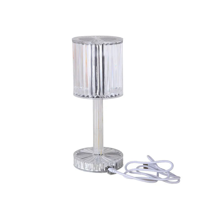 Amber K9 crystal table lamp with double-layered lampshade on a modern bedside table, warm LED light on medium brightness