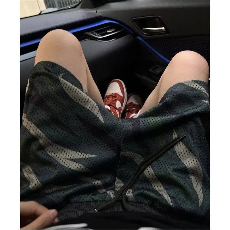Men's camouflage pattern mesh shorts in straight-leg cut on mannequin