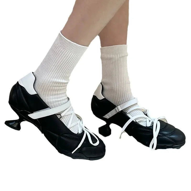 Women's silver lace-up bow sports shoes with mid heel and round toe on white background