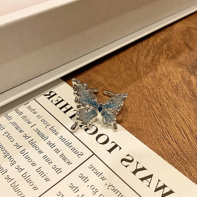 Copper butterfly women's ring with oil-drip finish showing open-loop design