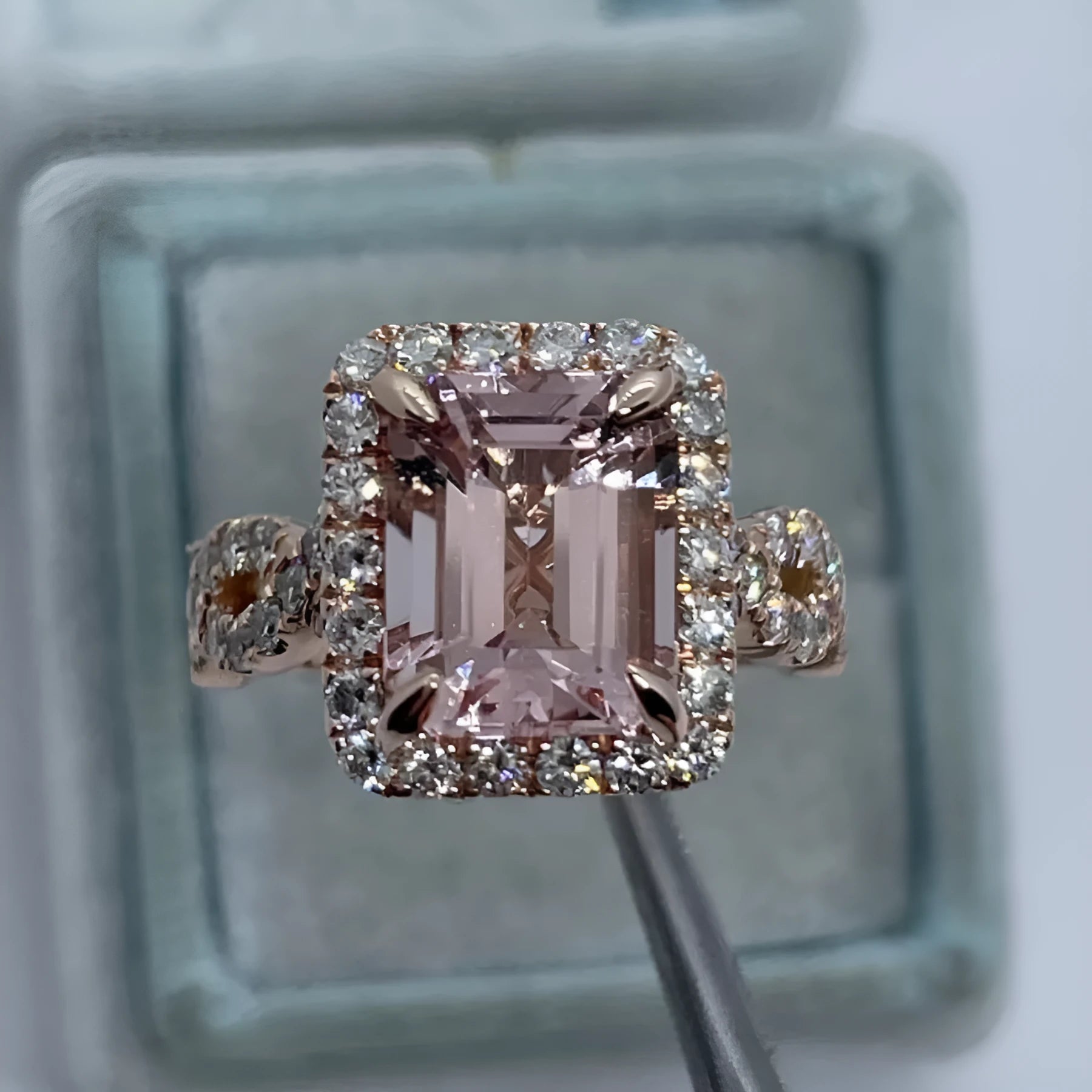 A geometric-shaped rose gold alloy ring on a plain background.