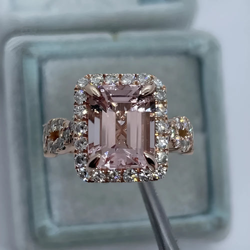 A geometric-shaped rose gold alloy ring on a plain background.