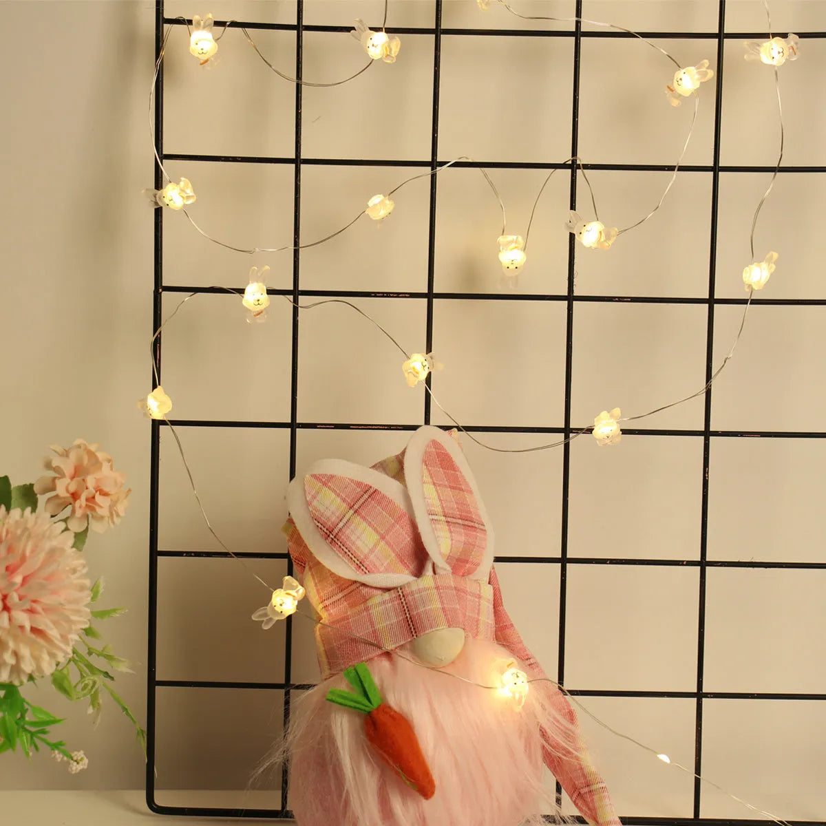 Easter LED bunny string lights with carrot and transparent white rabbit bulbs on a dark background