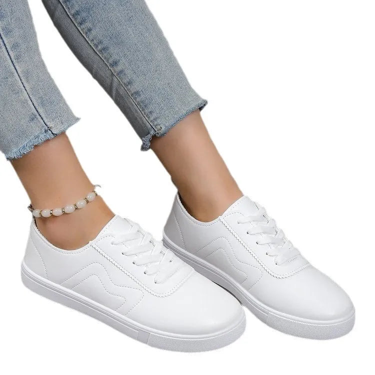 White round toe lace up casual shoes with platform heel on a flat surface