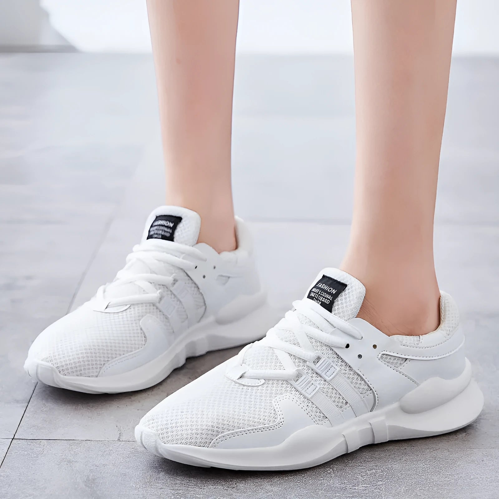 Breathable hollow out mesh sneakers in black and white colour options showing mesh upper construction