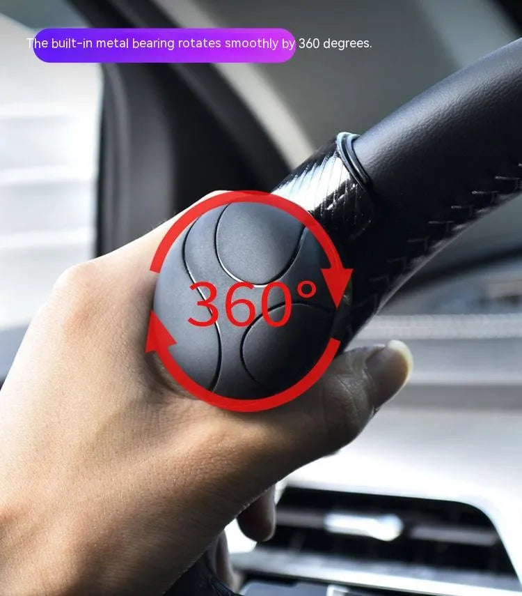 Black silicone steering wheel assist ball with metal bearing for single-handed steering assistance