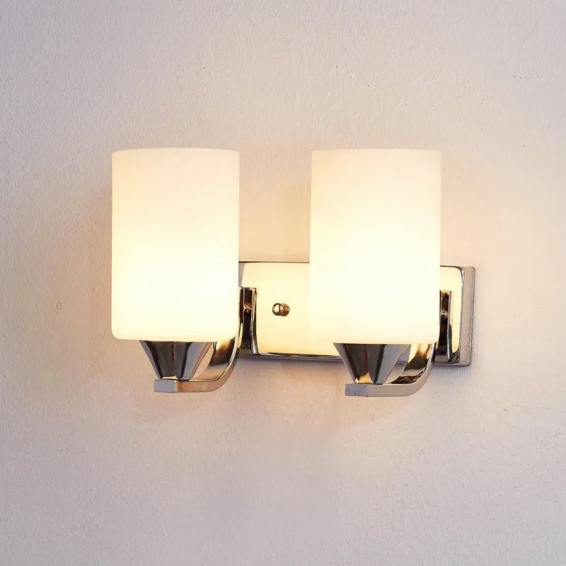 Modern chrome and glass wall lamp with single head design showing glass lampshade and metallic finish