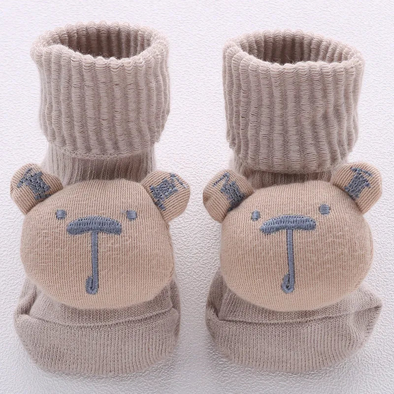 Cotton baby socks in multiple colours and prints including panda, lion, bows, and stars on a white background.