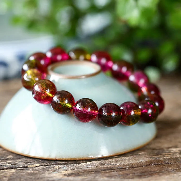 Women's handmade watermelon crystal bracelet showing pastoral design elements on wrist
