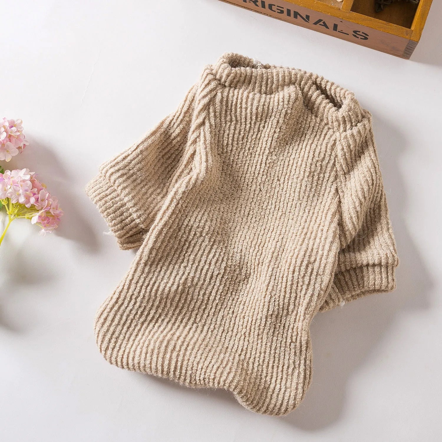 Brown cloth pullover sweater on a small dog, showing casual style and fit for breeds like Bichon or Pomeranian.