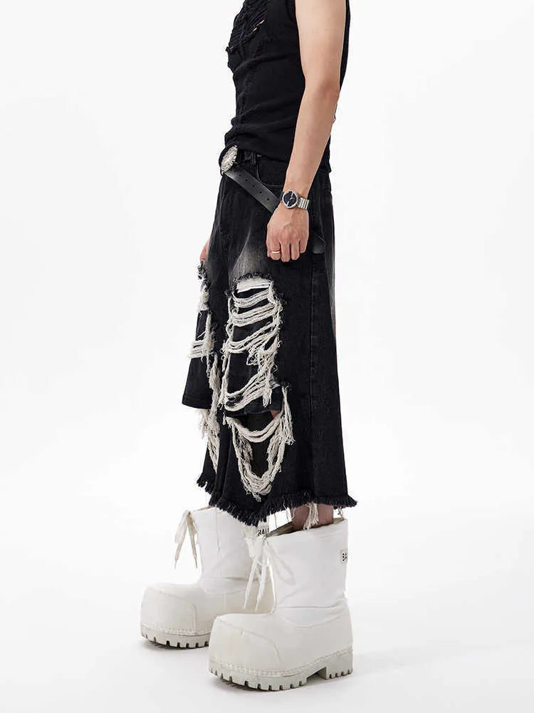 Woman wearing black cropped wide-leg jeans with a mid-high waist and ripped patchwork details
