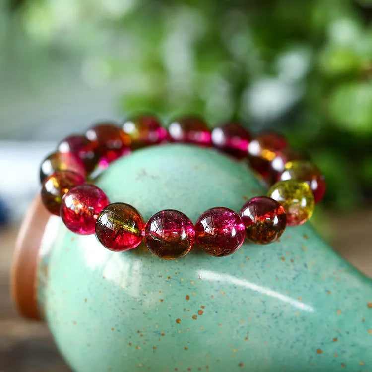 Women's handmade watermelon crystal bracelet showing pastoral design elements on wrist