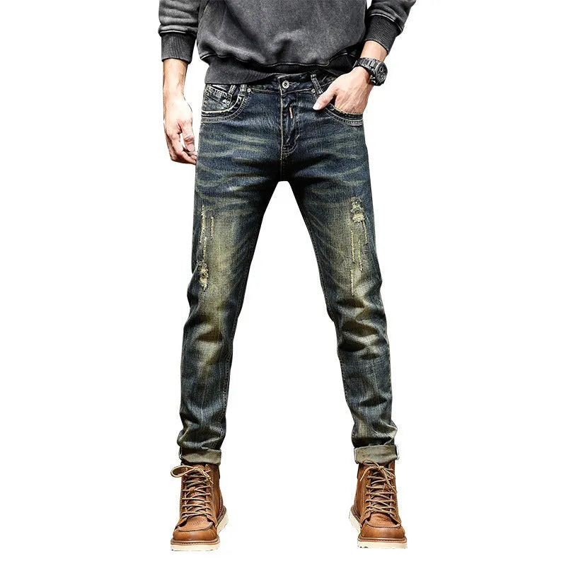 Men's skinny fit retro blue jeans with a zip fly closure laid flat.