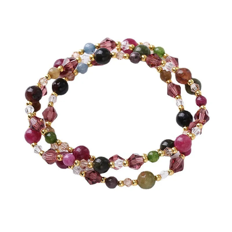 Colourful handmade crystal bracelet with tourmaline, strawberry quartz, and amethyst beads on an adjustable cord.