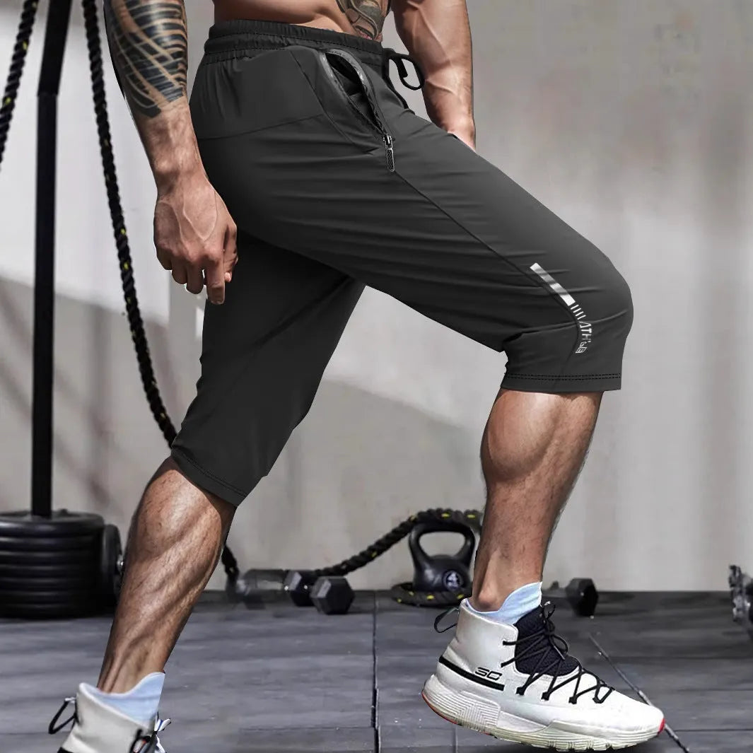Men's cropped nylon sports trousers in straight cut available in black, blue, gray and khaki