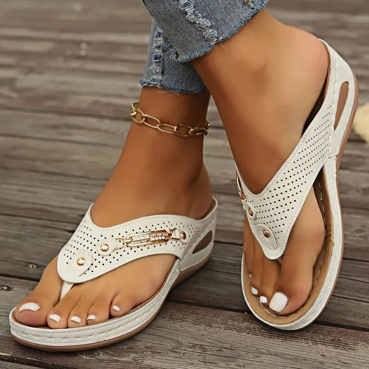 Women's beige retro flip flops showing herringbone patterned footbed and strap.