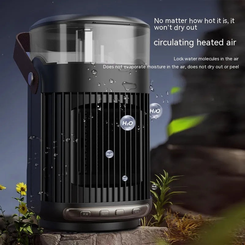 Black compact portable ceramic heater with humidifier unit on a table.